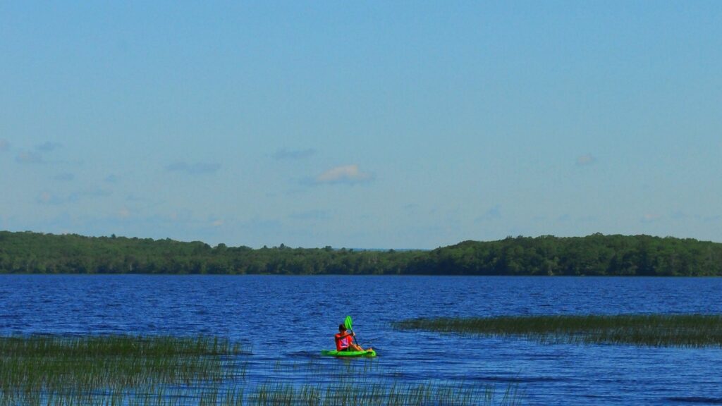 A person kayaking on Worden Pond in Rhode Island