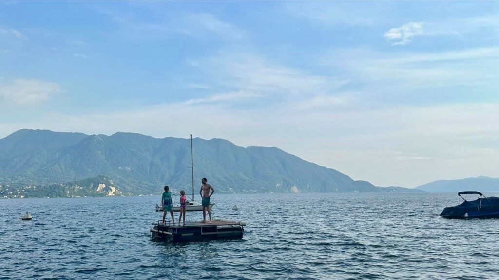 Young people on a swimming platform in Lake Maggiore in Italy