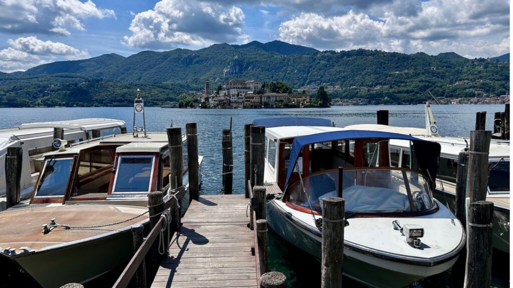 View of Lake Orta from Orta San Giulio with boats in foreground and Isola San Giulio in background