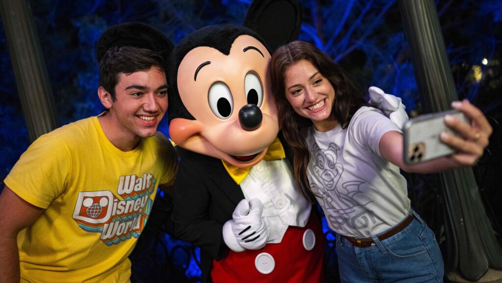 Couple taking a selfie with Mickey Mouse