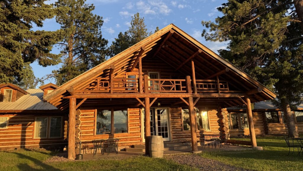 The exterior of a log cabin at Double Arrow Lodge
