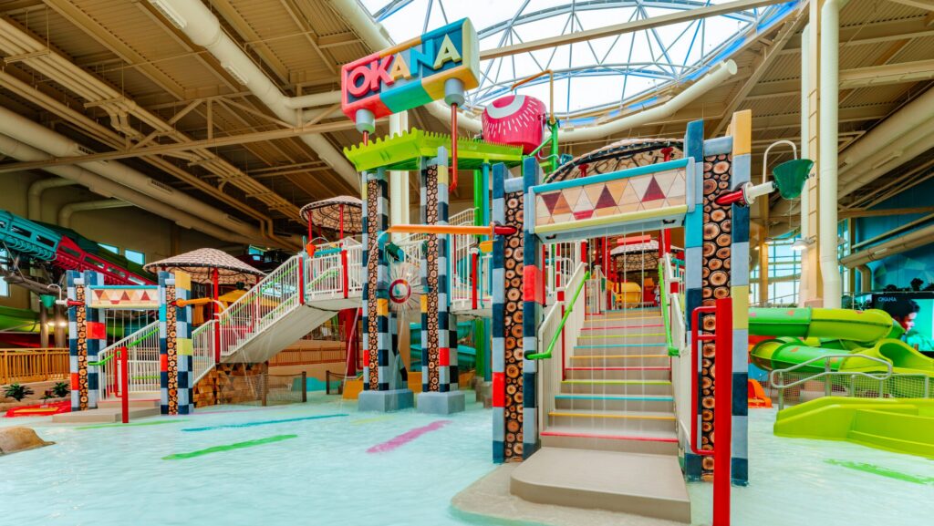 A splash zone at the indoor water park at Okana Resort