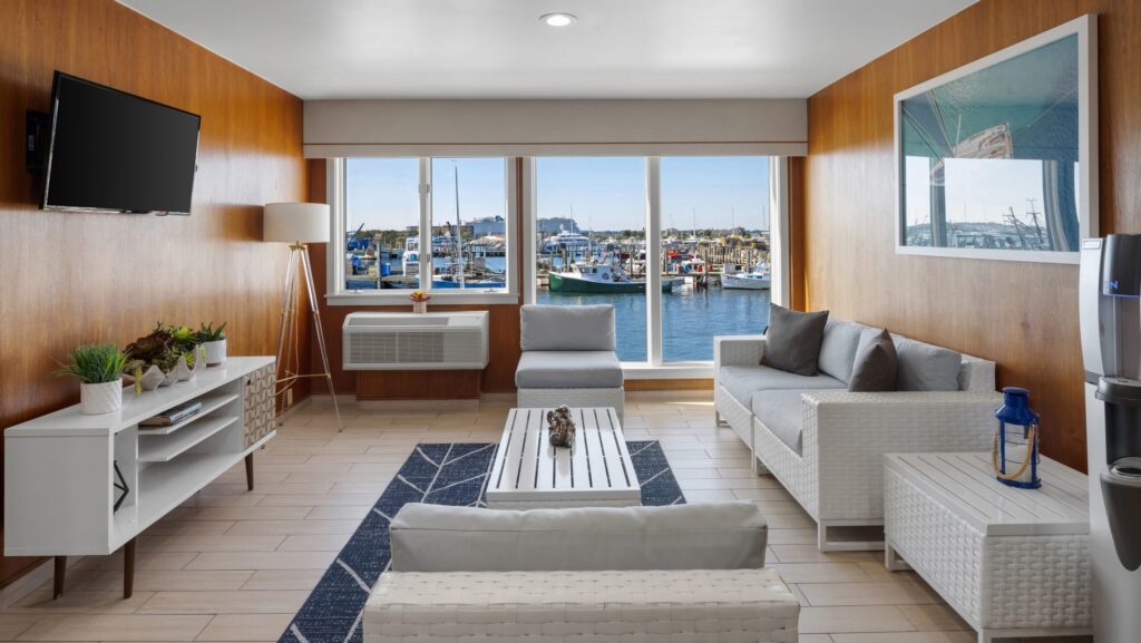 A living room space overlooking the marina at Club Wyndham Long Wharf in Newport, RI
