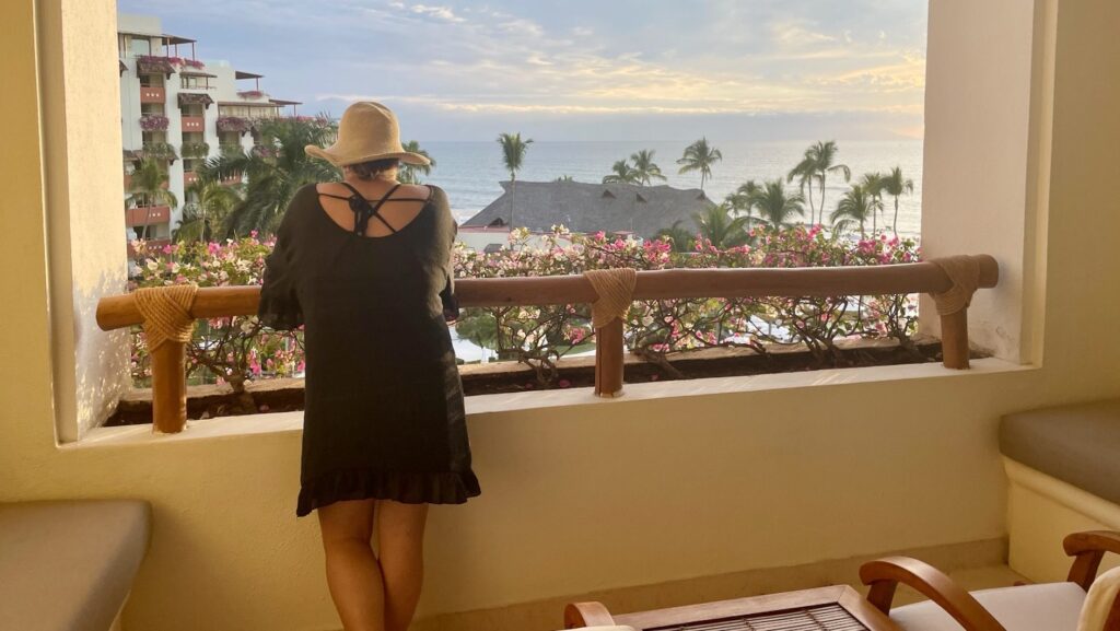 person looking out at the view from a balcony at the Grand Velas Riviera Nayarit