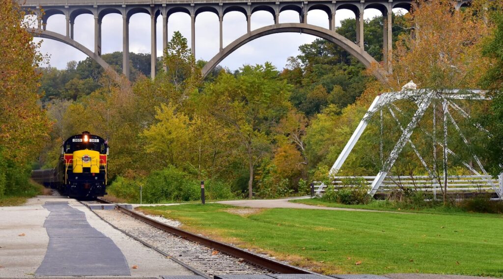 The Cuyahoga Valley Scenic Railroad traveling by bridges and fall foliage