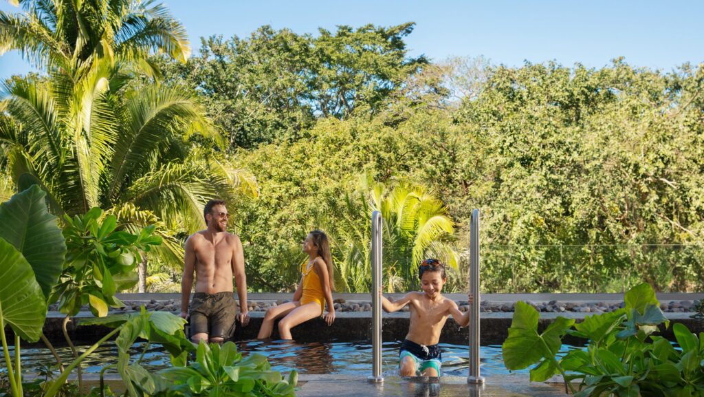 Family relaxing in the pool at a Dreams Bahia Mita swim-out suite