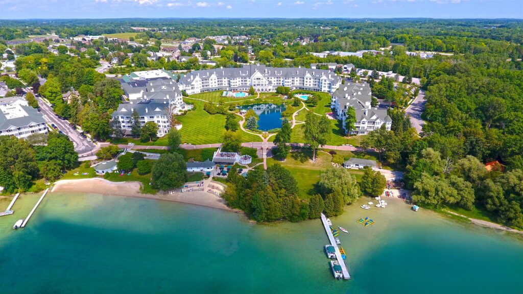 An aerial view of the lake, dock, and hotel at The Osthoff Resort