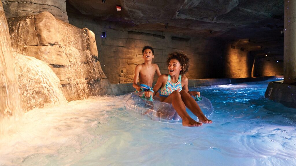 Two kids riding on the lazy river at SoundWaves at Gaylord Opryland