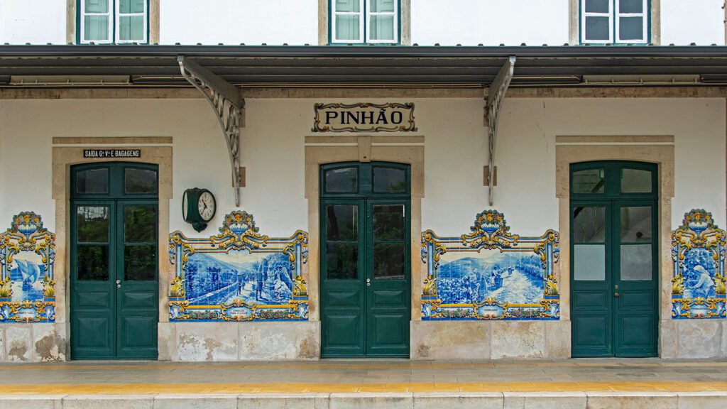 Closeup of building with blue tiles comprising an intricate mural