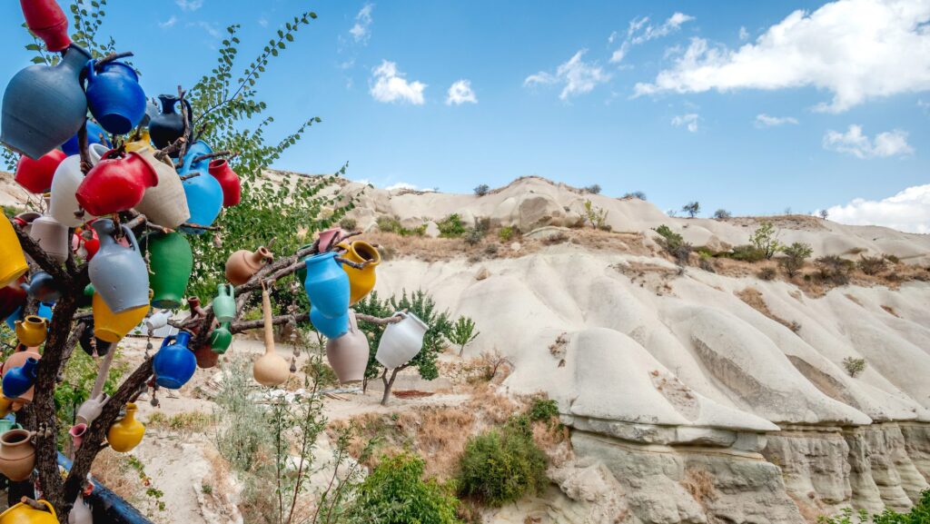 Tiny colorful vases hanging on tree branch in turkish Cappadocia