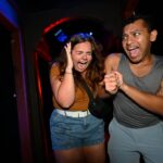 Two people going through a Halloween Horror Nights House at Universal Orlando Resort