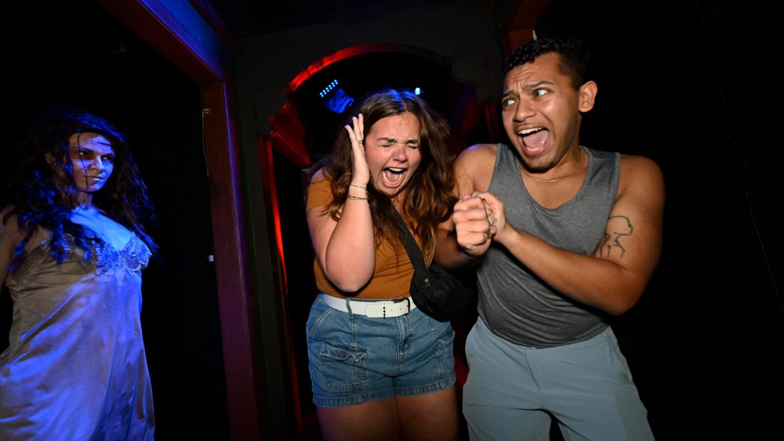 Two people going through a Halloween Horror Nights House at Universal Orlando Resort