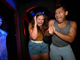 Two people going through a Halloween Horror Nights House at Universal Orlando Resort