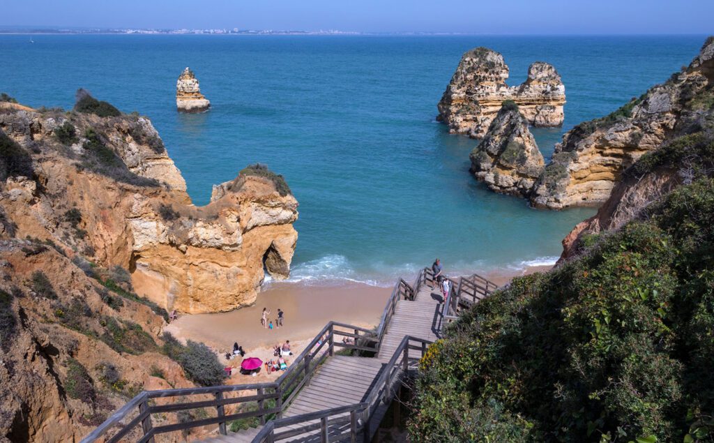 Steps leading down to a rocky beach and the ocean