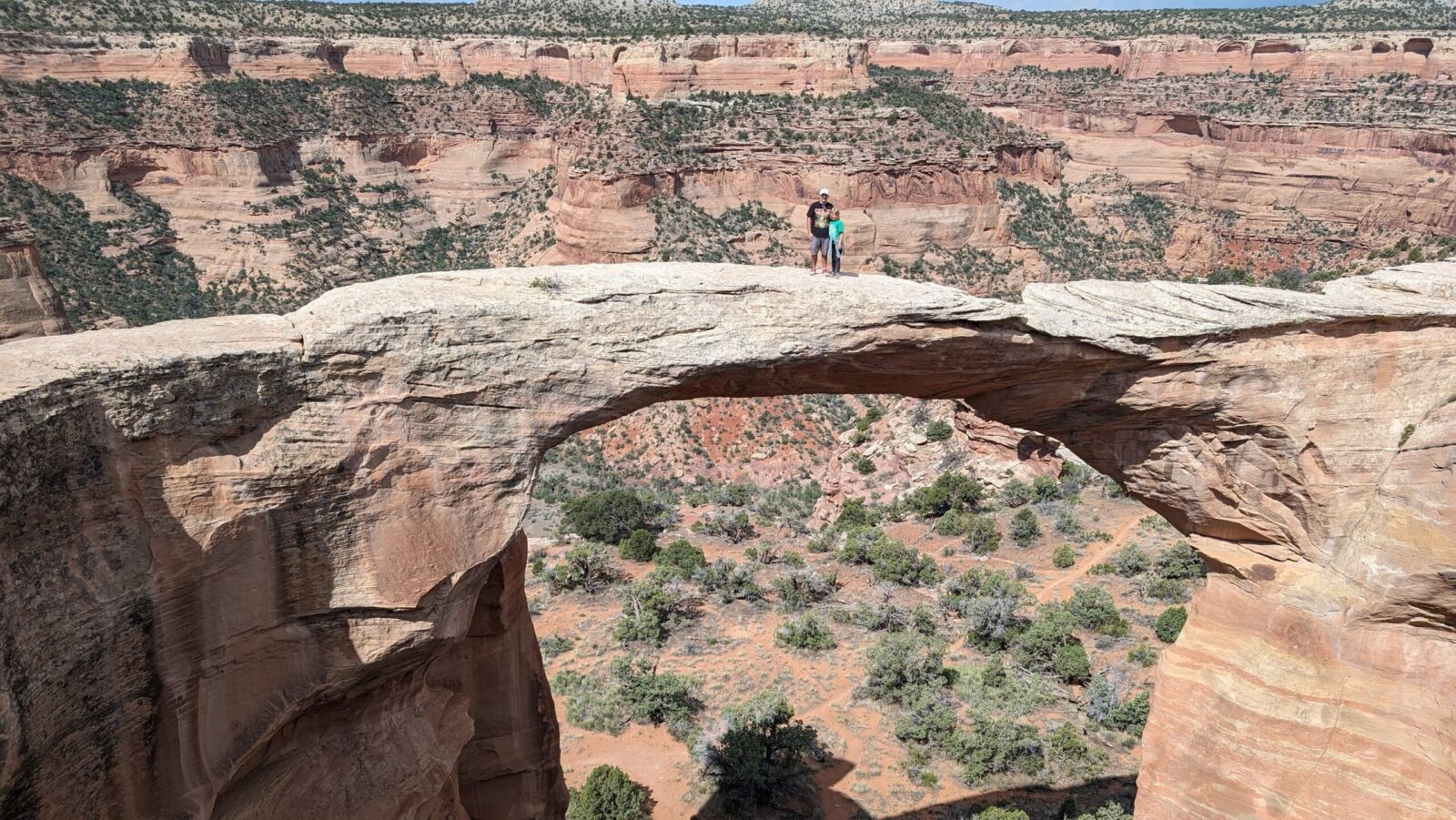 Wesley and Crosby stand atop an arch in Rattlesnake Canyon in Grand Junction, Colorado (Photo: Cynthia J. Drake)