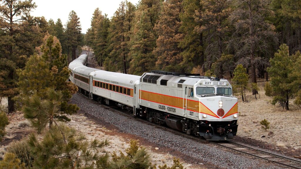 The Grand Canyon Railway traveling on tracks through the trees