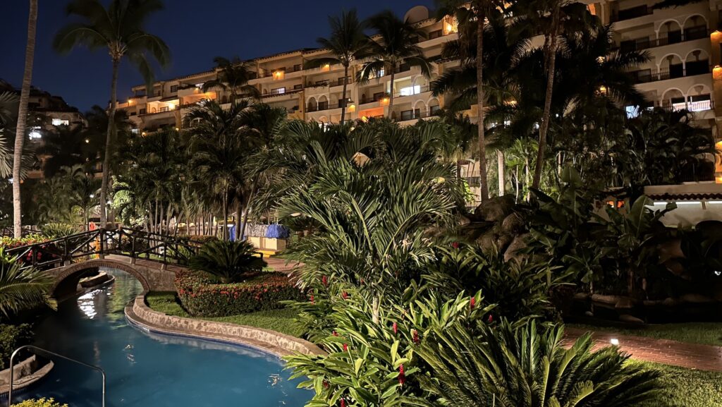 view of resort pool and grounds at night at Velas Vallarta resort in Puerto Vallarta