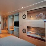 Cruise ship cabin with bunk beds built into the wall