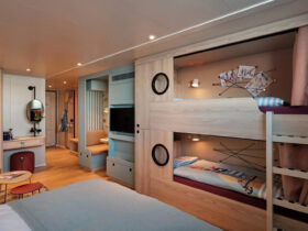 Cruise ship cabin with bunk beds built into the wall