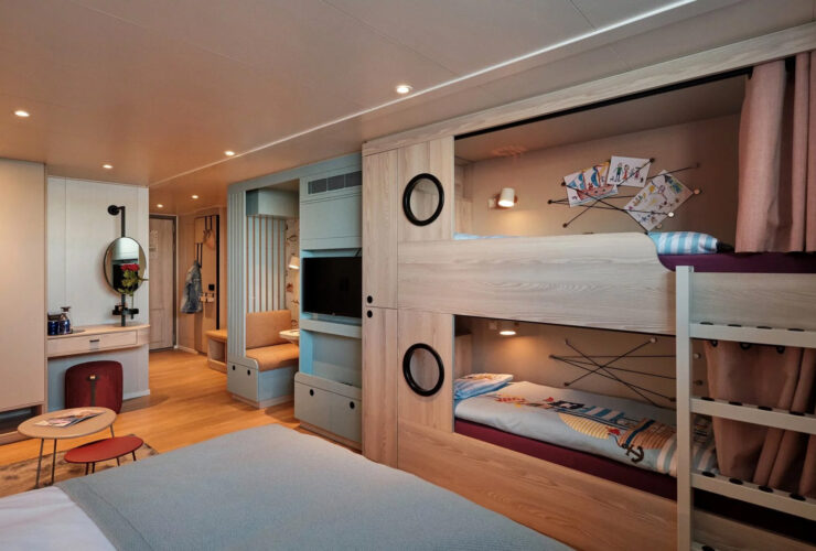 Cruise ship cabin with bunk beds built into the wall