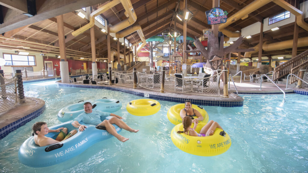 A family floating in a lazy river at an indoor water park