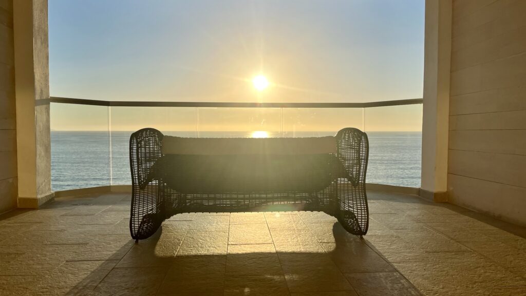 sunset at Hilton Vallarta Riviera All-Inclusive Resort with couch and balcony