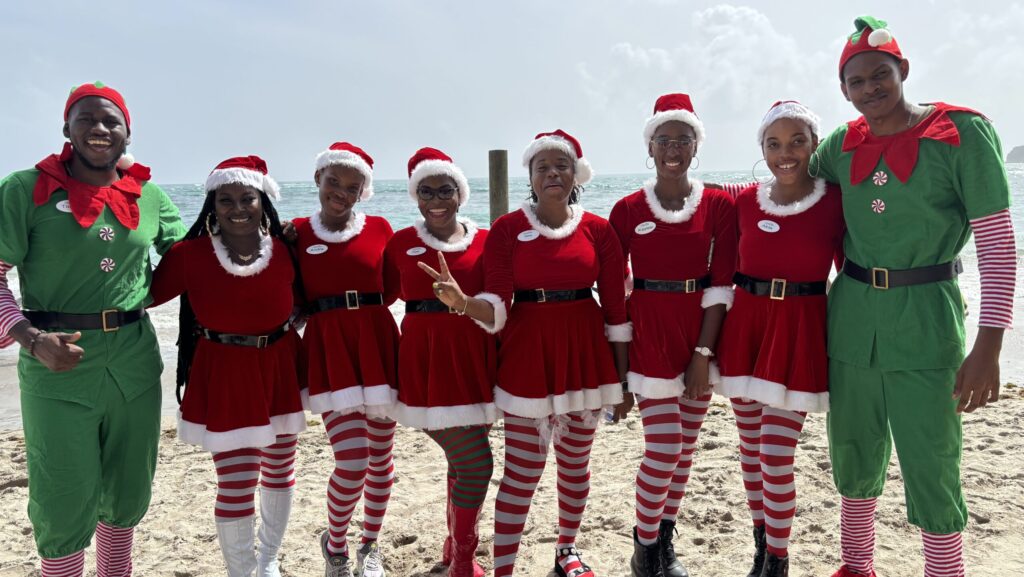 Staff at Coconut Bay Beach Resort & Spa on the beach dressed as elves and Santa's helpers for Christmas