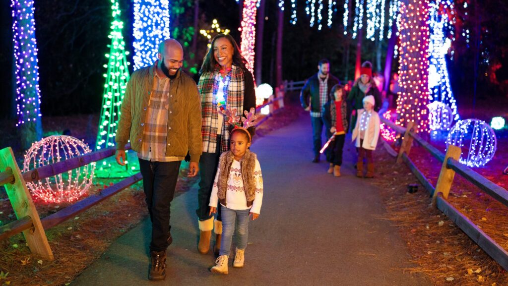 Two families walking through the holiday light display at Calloway Resort & Gardens
