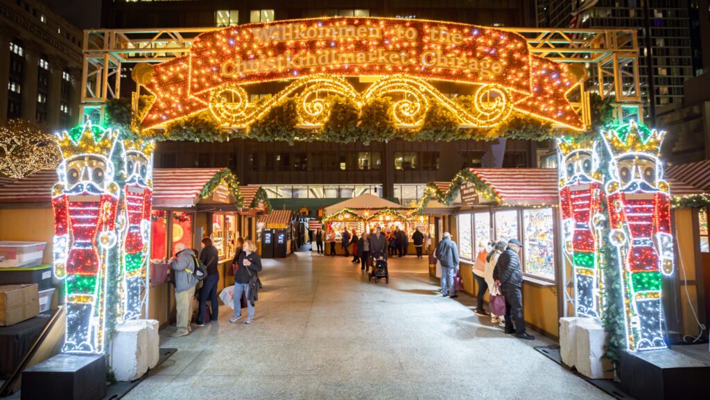 An entrance to the Christkindlmarket Chicago lit up with Christmas lights and nutcrackers