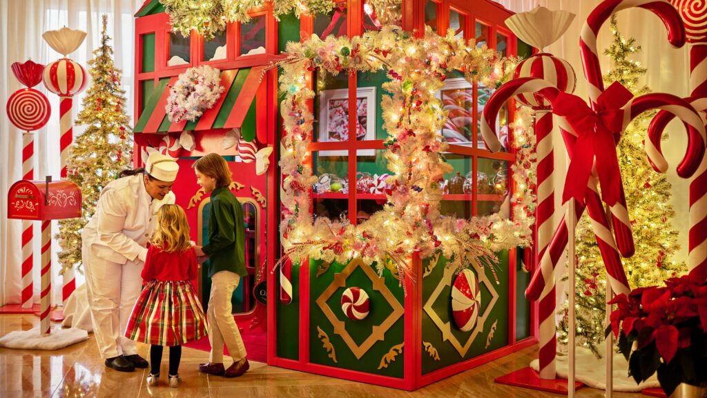 Kids getting treats from a chef at the over-the-top holiday Candy Shoppe at The Peninsula Chicago