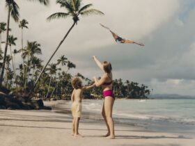 Two kids flying a kite on a beach