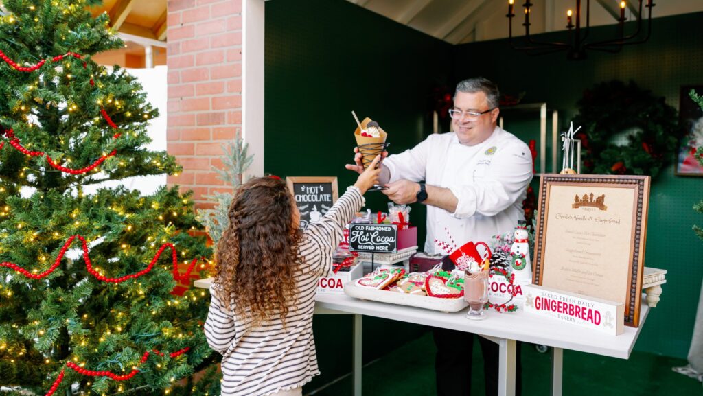A girl getting a treat from a chef at Grande Lakes Orlando
