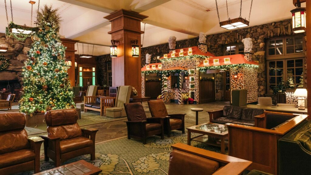 A Christmas tree and other decorations in the lobby of The Omni Grove Park Inn & Spa which has leather furnishings and stone and wood accents