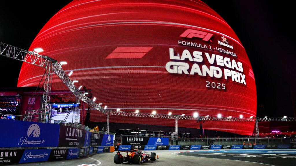 Formula 1 car driving past The Sphere in Las Vegas
