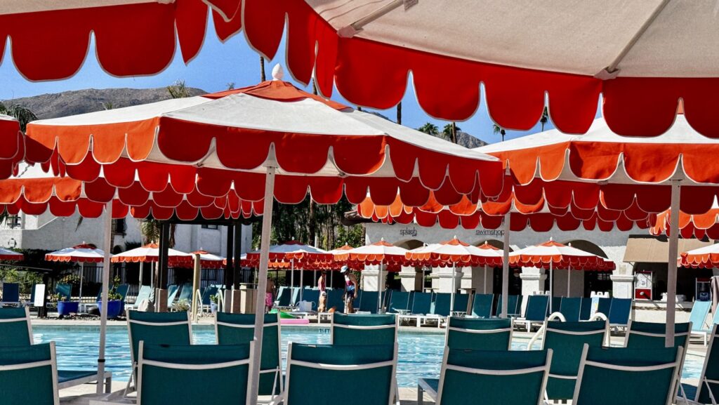 family pool with umbrellas and chaise loungers at the Omni Ranch Las Palmas