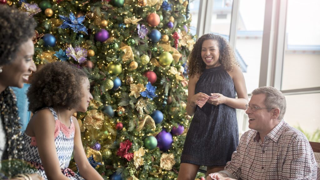 Family gathered around a Christmas tree