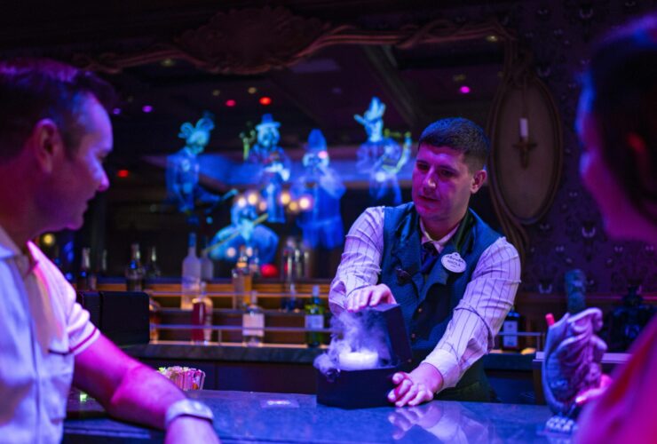 Guests inside the Haunted Mansion Parlor