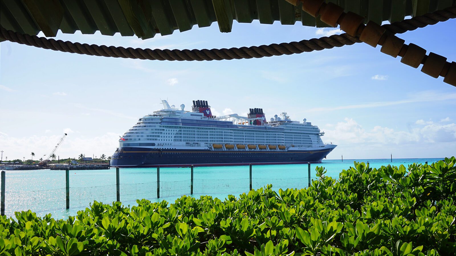 Cruise ship docked in ocean on sunny day