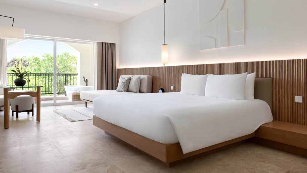 A guest room done up in soothing neutrals and wood tones at Kimpton Tres Rios