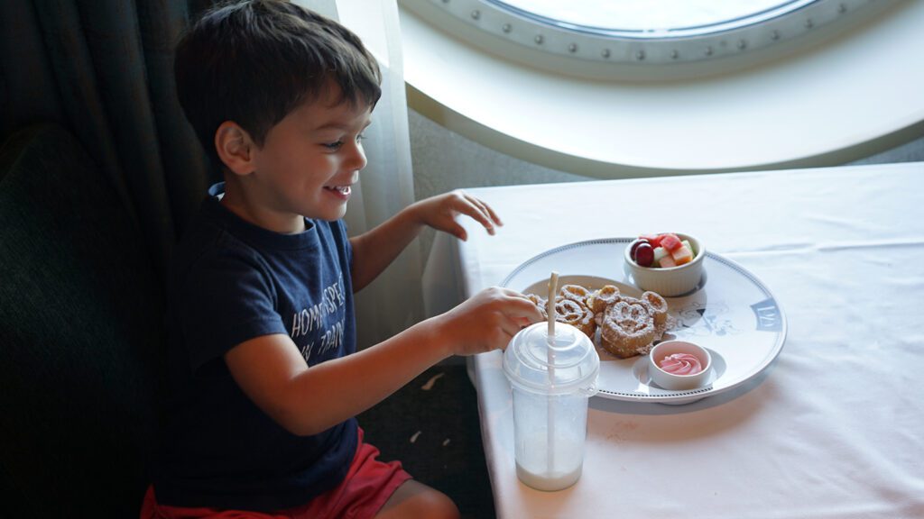 Young boy eating waffles on cruise ship