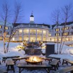 An exterior nighttime snowy view of The Sagamore Resort