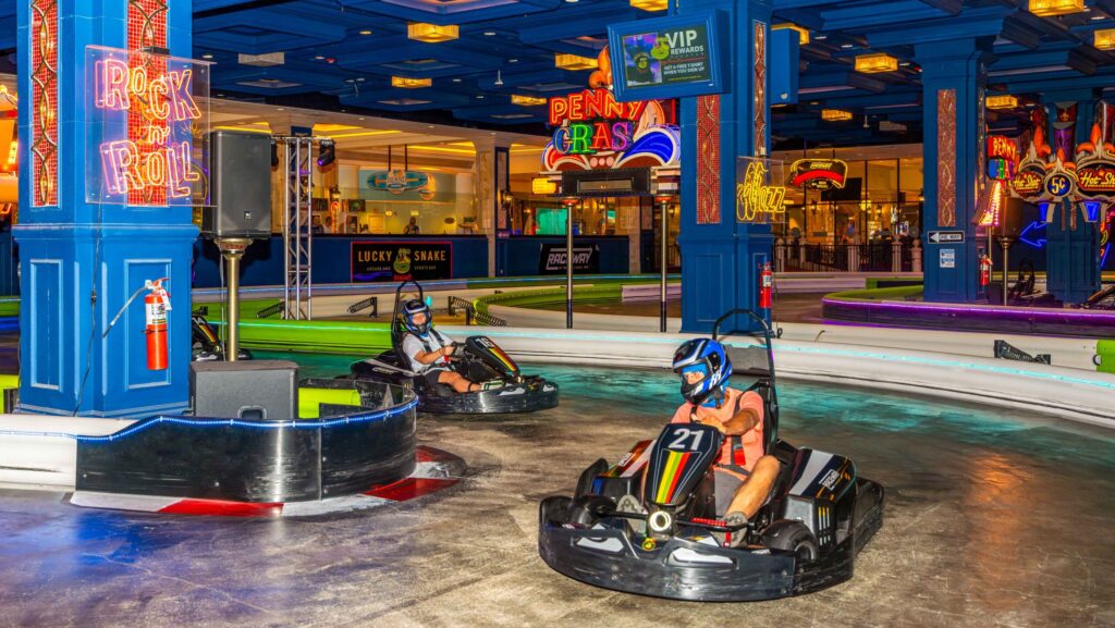 Two people riding on the indoor go-karts at Showboat Resort Atlantic City