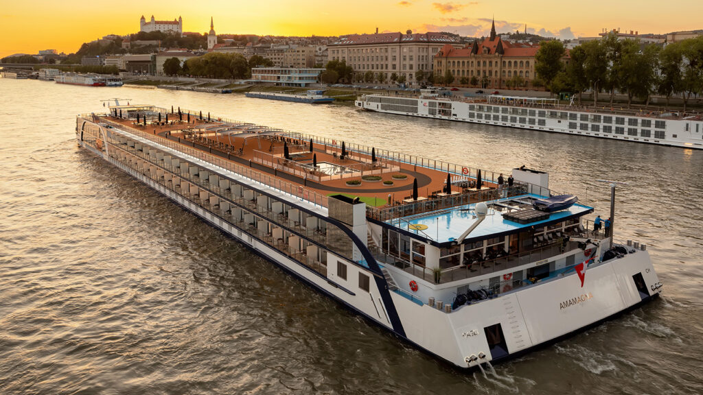 Large river cruise ship sailing at sunset