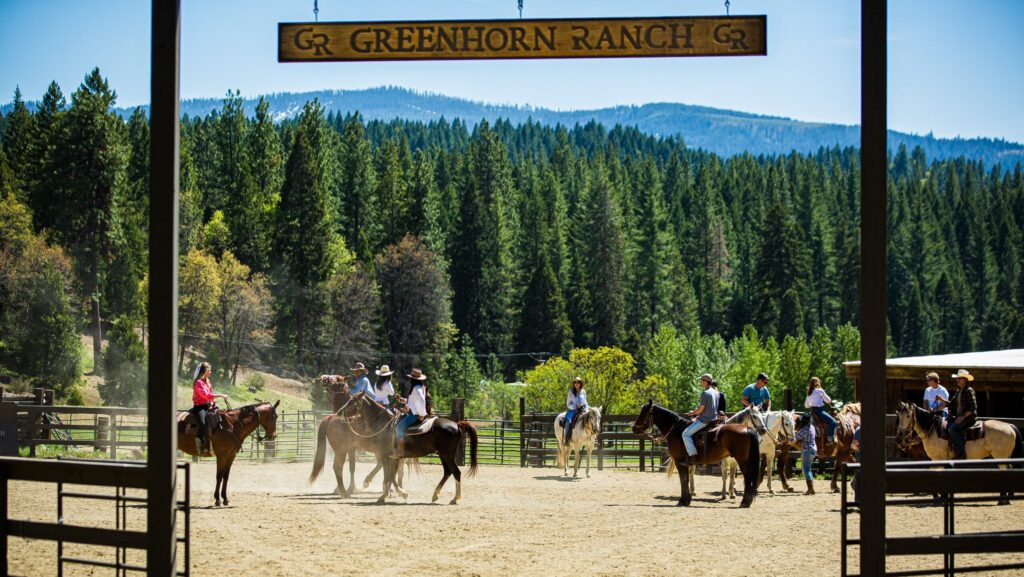 A group of people on horses waiting to start a trail ride at Greenhorn Ranch