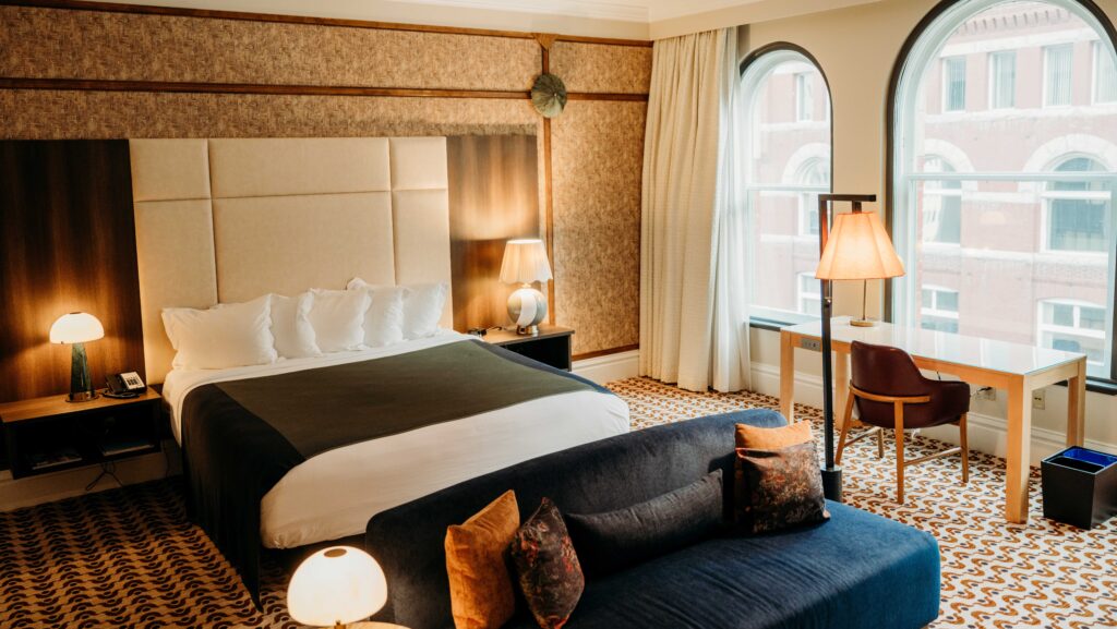 A stylish guest room with a king bed and  big windows at The Louie at Davenport Hotel