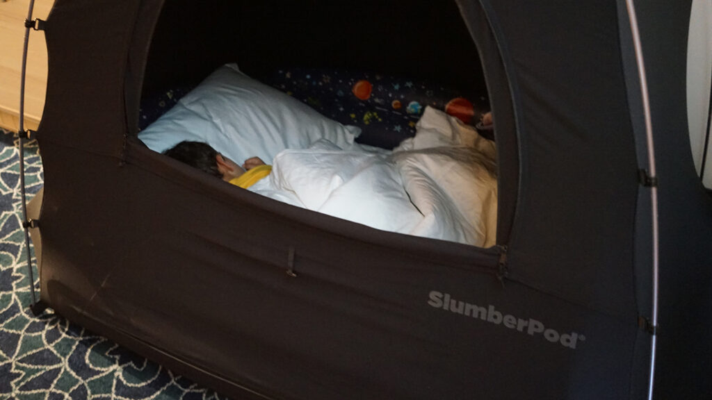 Young boy sleeping in tent