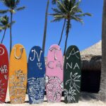 surfboards that say Club Med Punta Cana on the beach