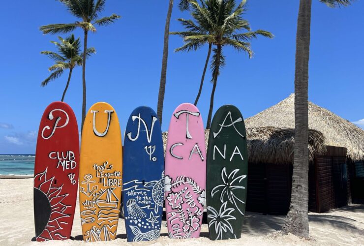 surfboards that say Club Med Punta Cana on the beach