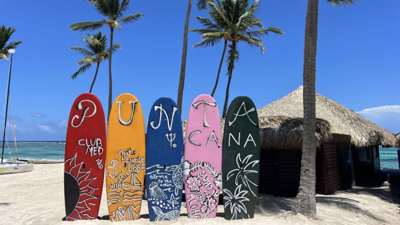 surfboards that say Club Med Punta Cana on the beach