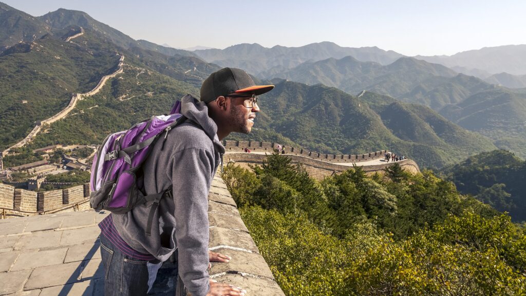 Man standing at the Great Wall of China on a group tour